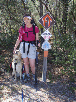 Brenda and Jake by a trail sign
