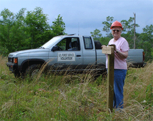 Gayle Jones proudly displaying her very plumb sign